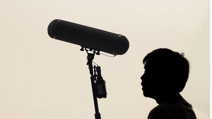 A sound operator working with a boom microphone